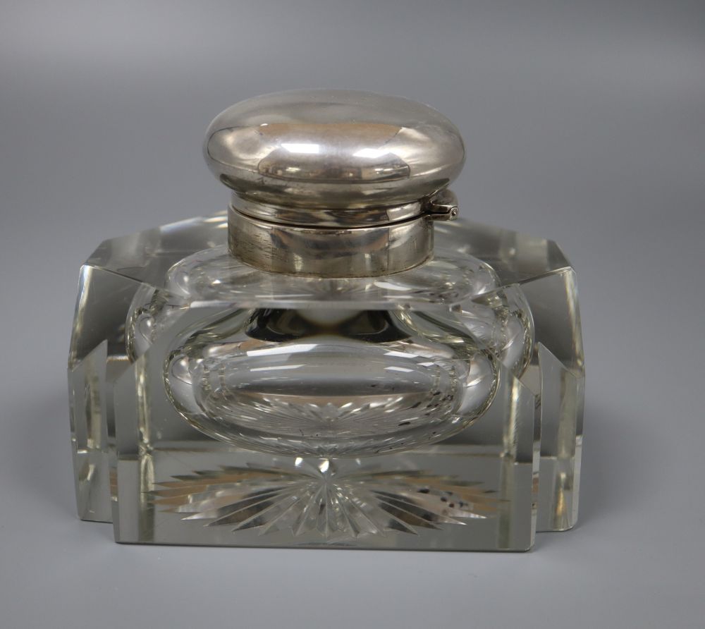 A George V silver mounted shaped cut glass inkwell, Alexander Clark * Co Ltd, Birmingham, 1917, height 11.4cm.